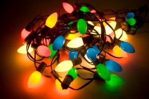 Tangled pile of colored Christmas lights on plexi-glass